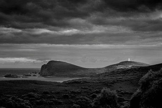 Black and white photograph of storm clouds over Bruny Island Tasmania coastline with dramatic light