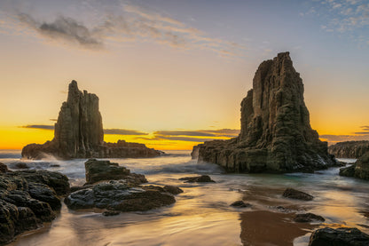 South Coast NSW sunrise dramatic coastline with golden orange light and blue ocean Bombo area