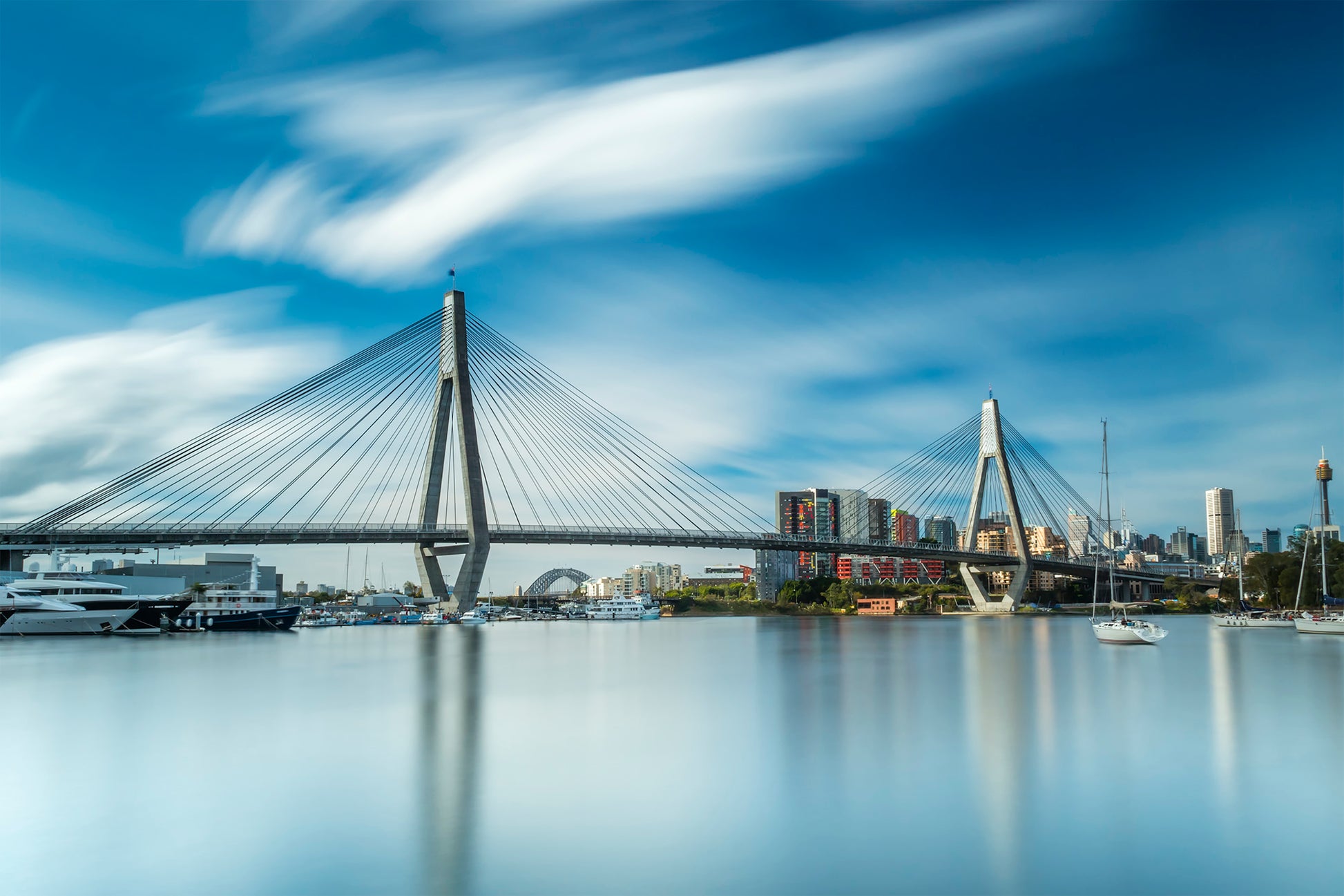Color long exposure photograph of Anzac Bridge reflections Black Wattle Bay Glebe foreshore Sydney painterly clouds