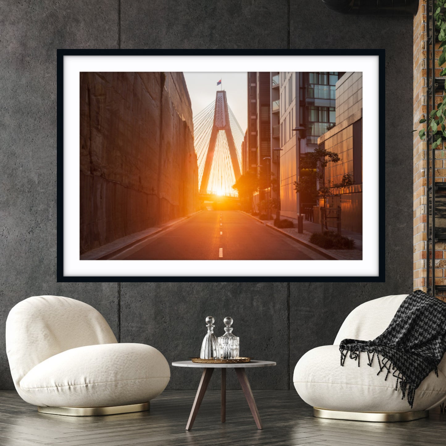 Framed fine art photography of golden hour light at Distillery Drive, Jacksons Landing, Sydney on a wall above two white chairs.