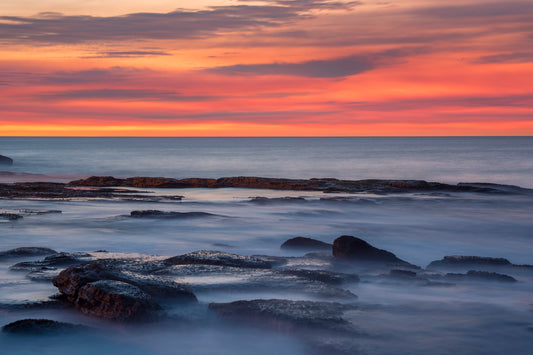 Abstract seascape photography Sydney with flowing water soft textures warm salmon and cool blue tones