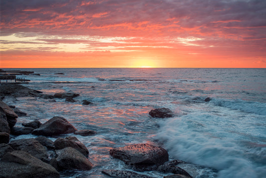 Atmospheric coastal sunrise Sydney with warm yellow and pink tones suggesting hope and anticipation