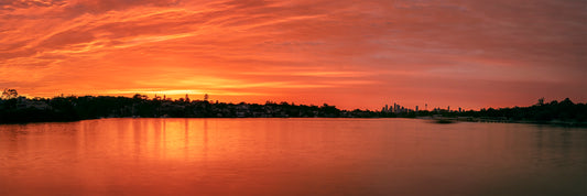 Color long exposure photograph of Cabarita Point wharf Parramatta River dawn ochre light ethereal ferry motion molten reflections