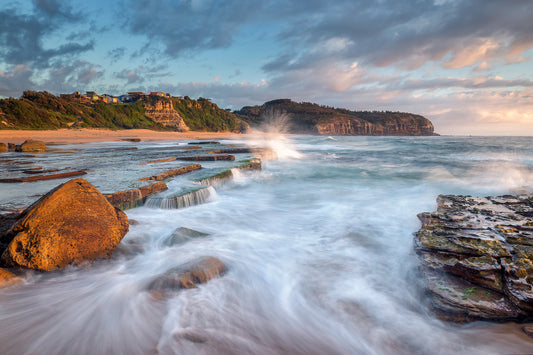 Turimetta Beach sunrise Sydney northern beaches with rock formations golden light and blue ocean