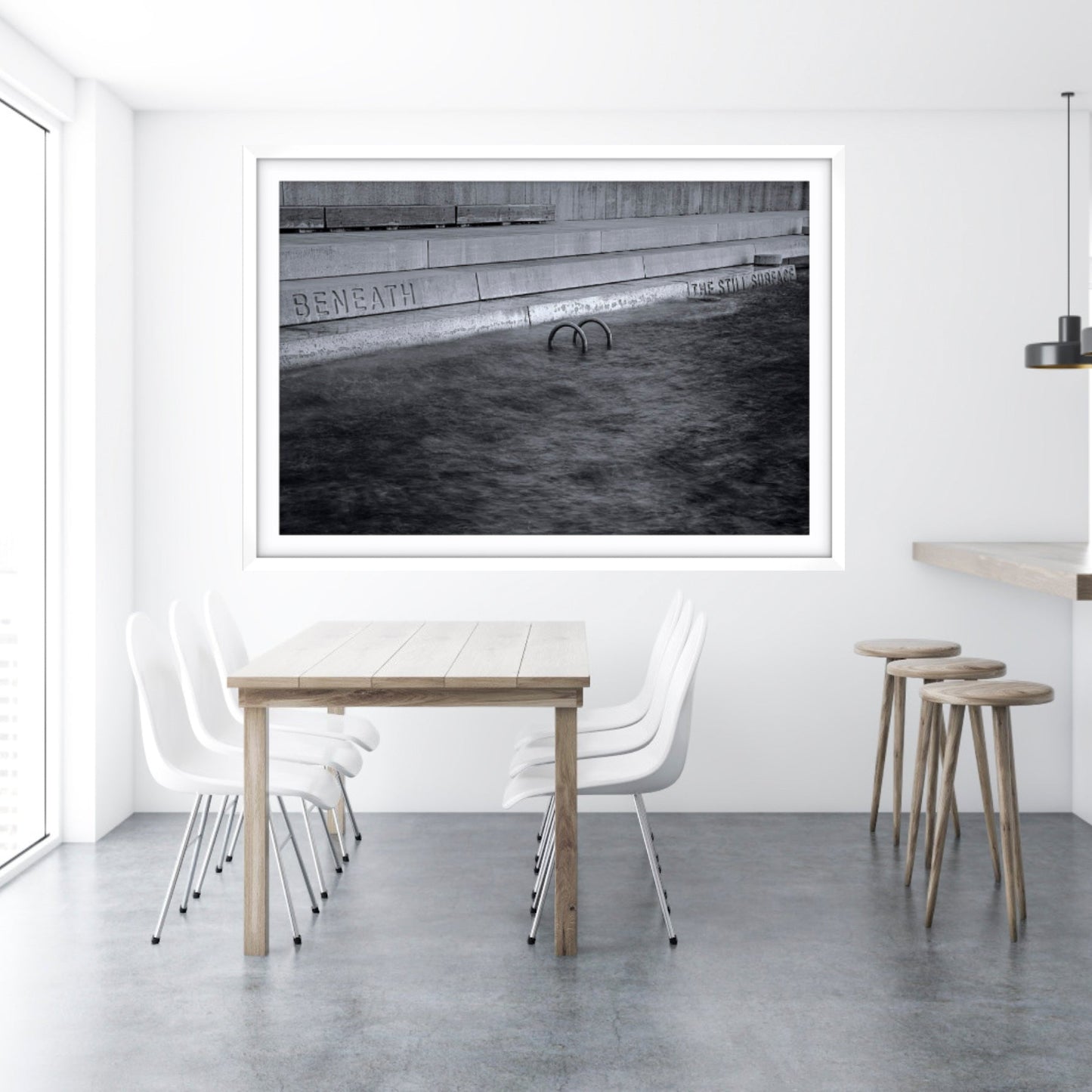 Framed fine art black and white abstract photograph taken in Jacksons Landing, Pyrmont, NSW on a wall above a dining table with chairs and stools.