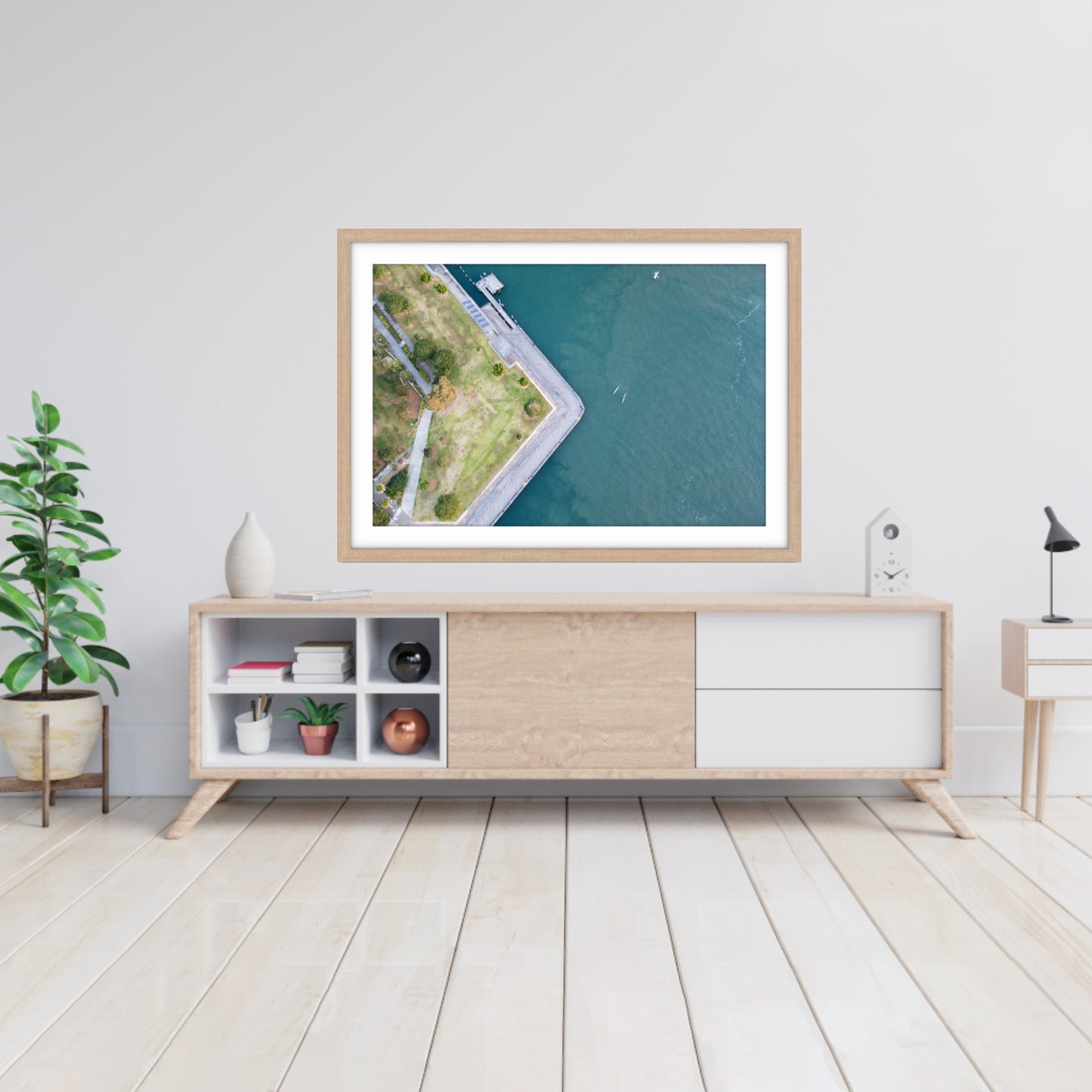 Fine art aerial photograph of Piramma Park, Jacksons Landing, Sydney on a wall above a wooden cabinet.