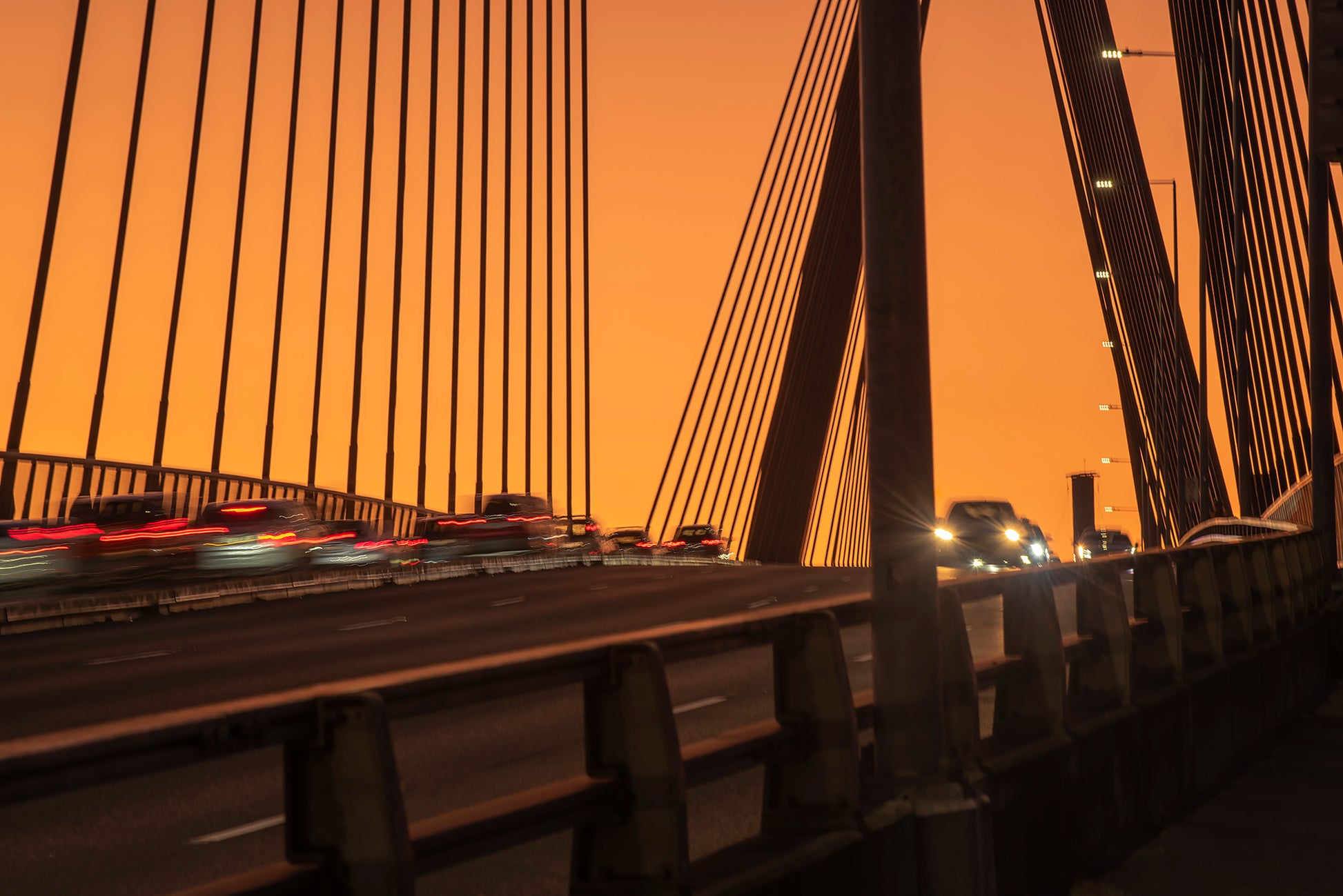 Anzac Bridge Sydney at dusk with red tail lights traffic light trails and memorial pylon
