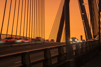 Anzac Bridge Sydney at dusk with red tail lights traffic light trails and memorial pylon