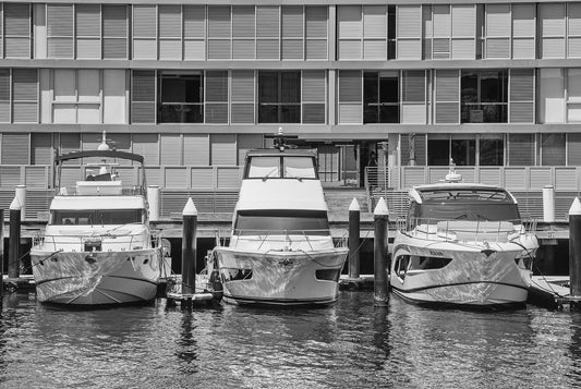 Black and white photograph of three luxury motor cruisers moored at Pyrmont marina Sydney Harbour waterfront