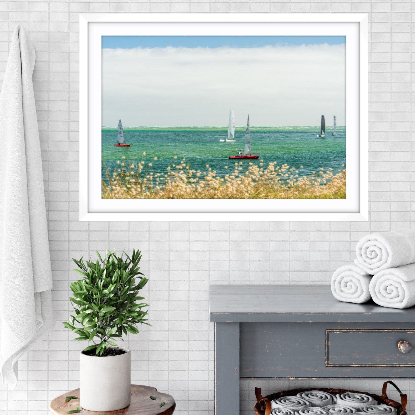 Framed fine art photographic print of sailboats racing on Anderson Inlet, Inverloch, Victoria in a bathroom setting. 