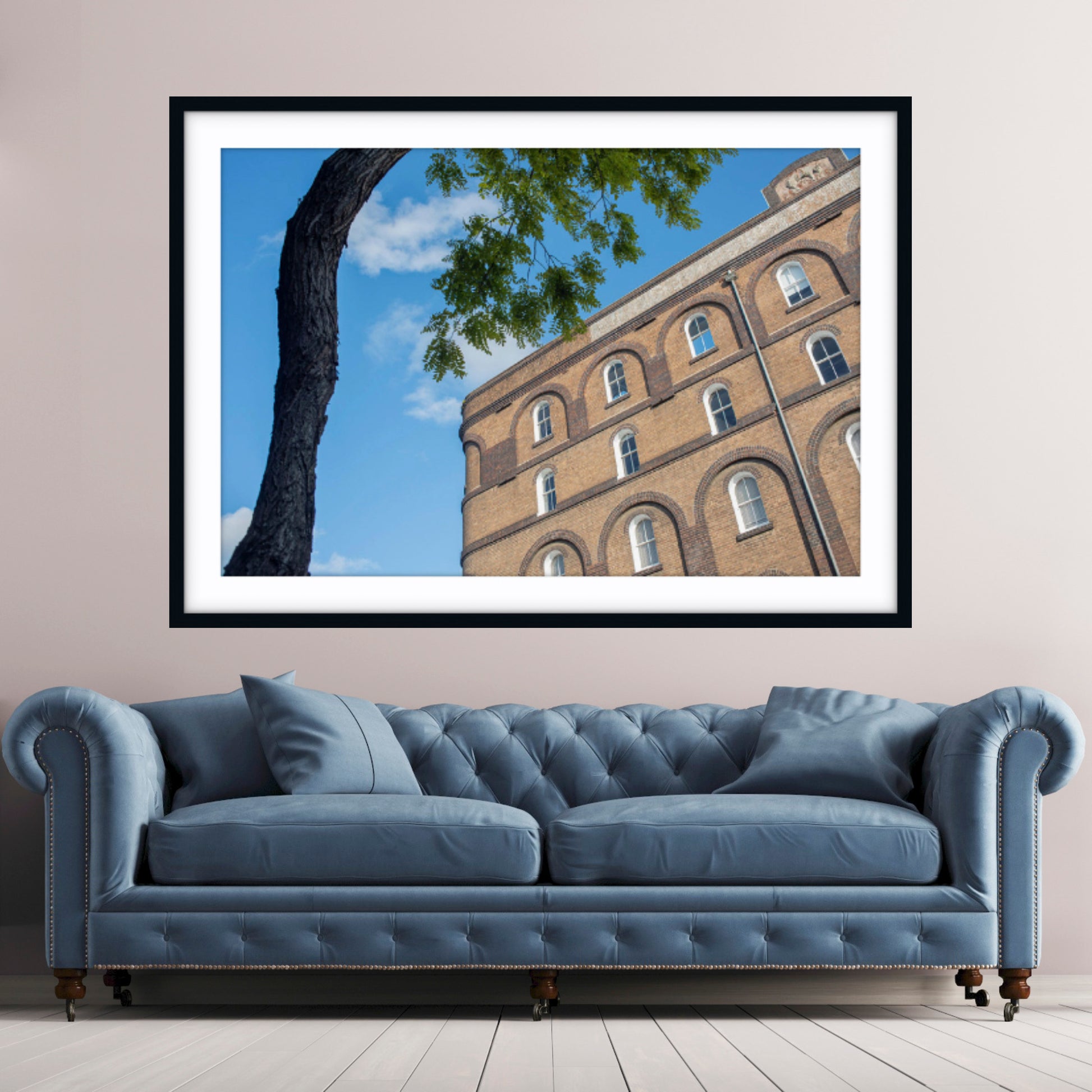 Framed fine art photograph of a rustic wool store in Pyrmont, Sydney, with a blue sofa in the foreground. 
