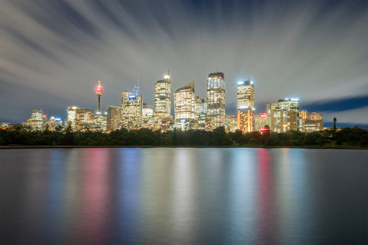 Color photograph of Farm Cove Sydney twilight with city light reflections in harbour water