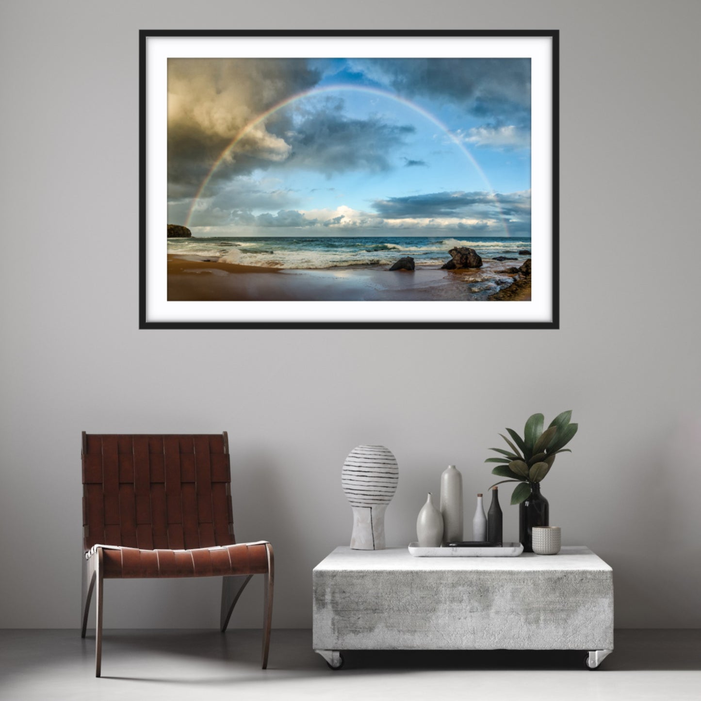 Framed fine art photograph of a rainbow over Turimetta Beach, Sydney on a wall above a modern interior setting.
