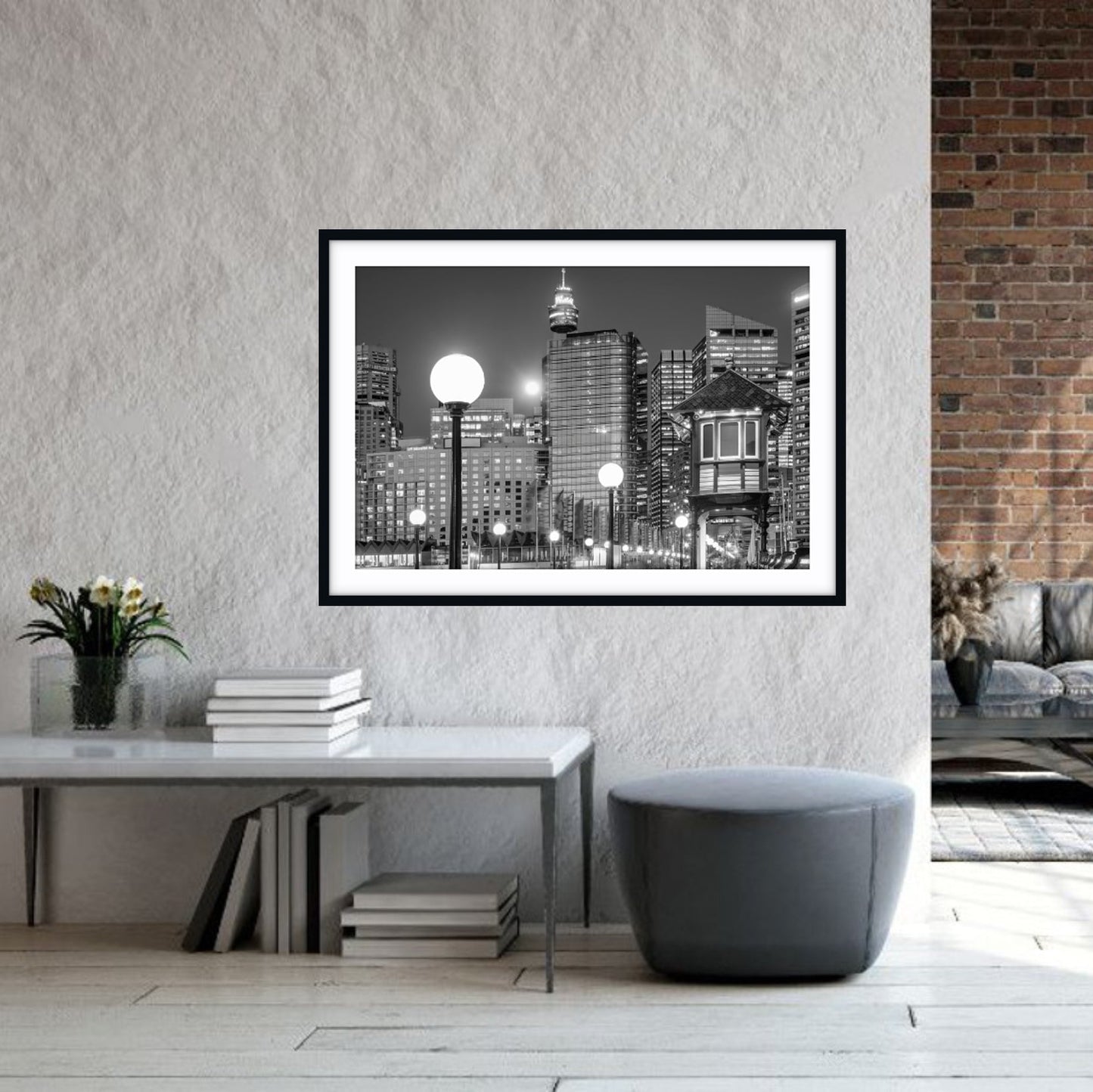 Framed Sydney CBD cityscape print on a wall in a modern living room.