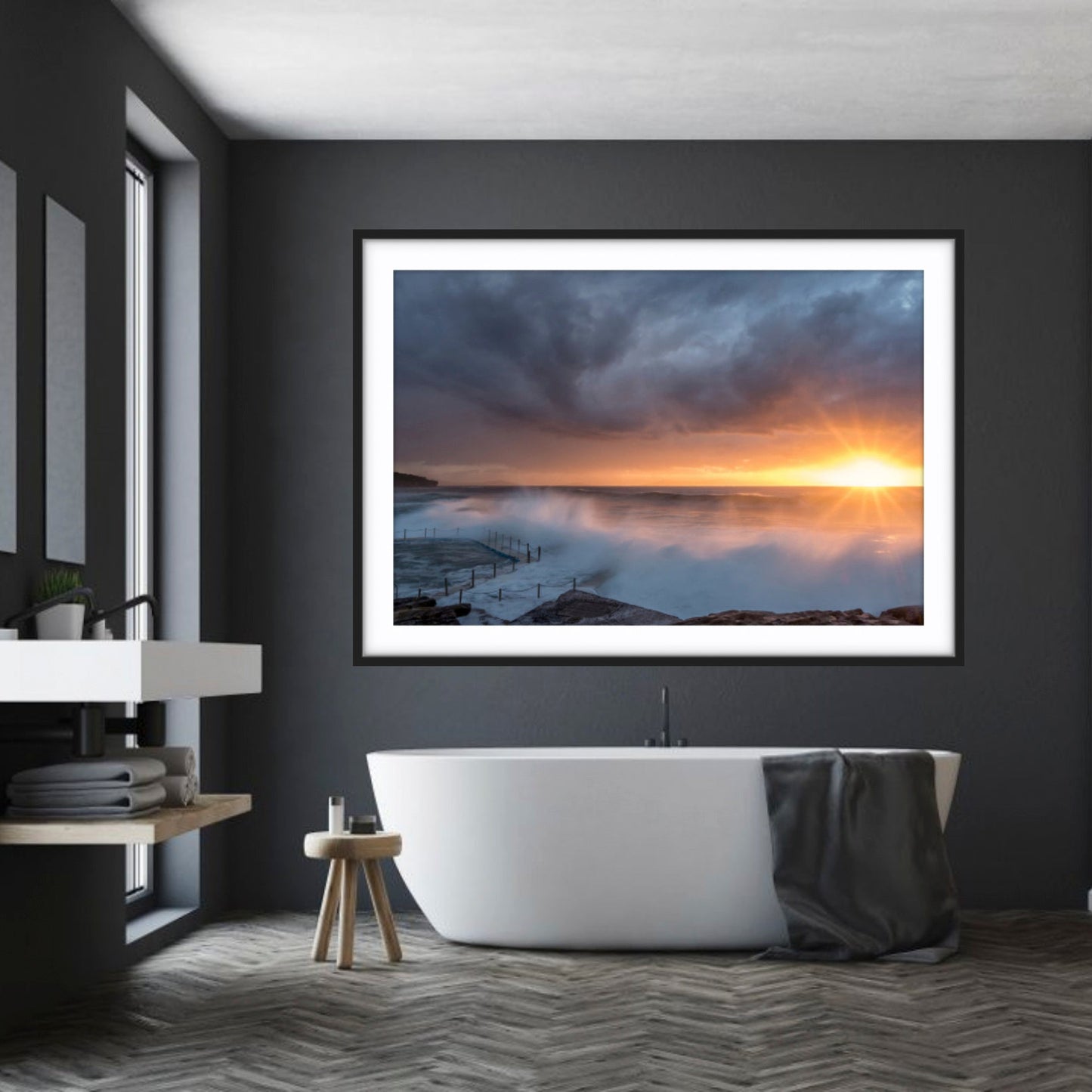 Bathroom with a large framed picture of a sunrise at South Curl Curl on a dark wall.