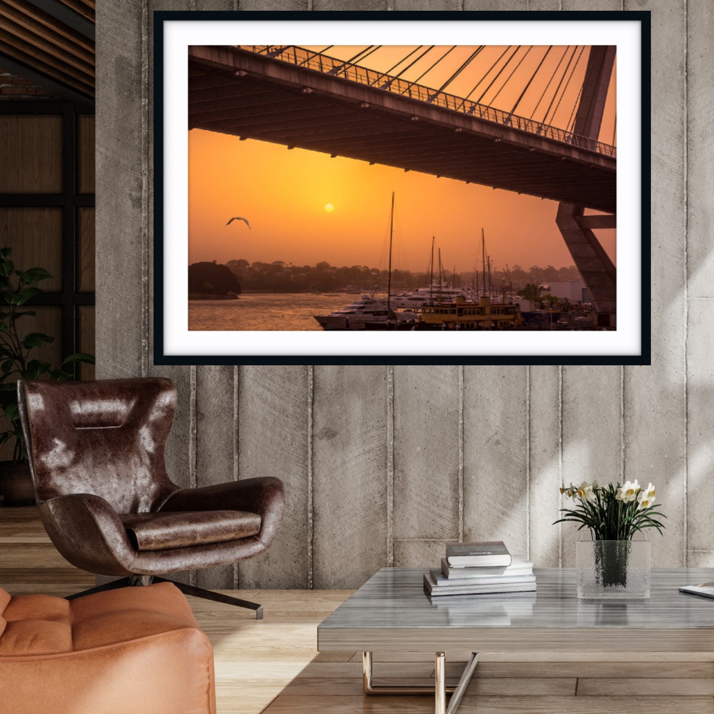 Framed fine art photograph of a sunset over Anzac Bridge in a living room setting.