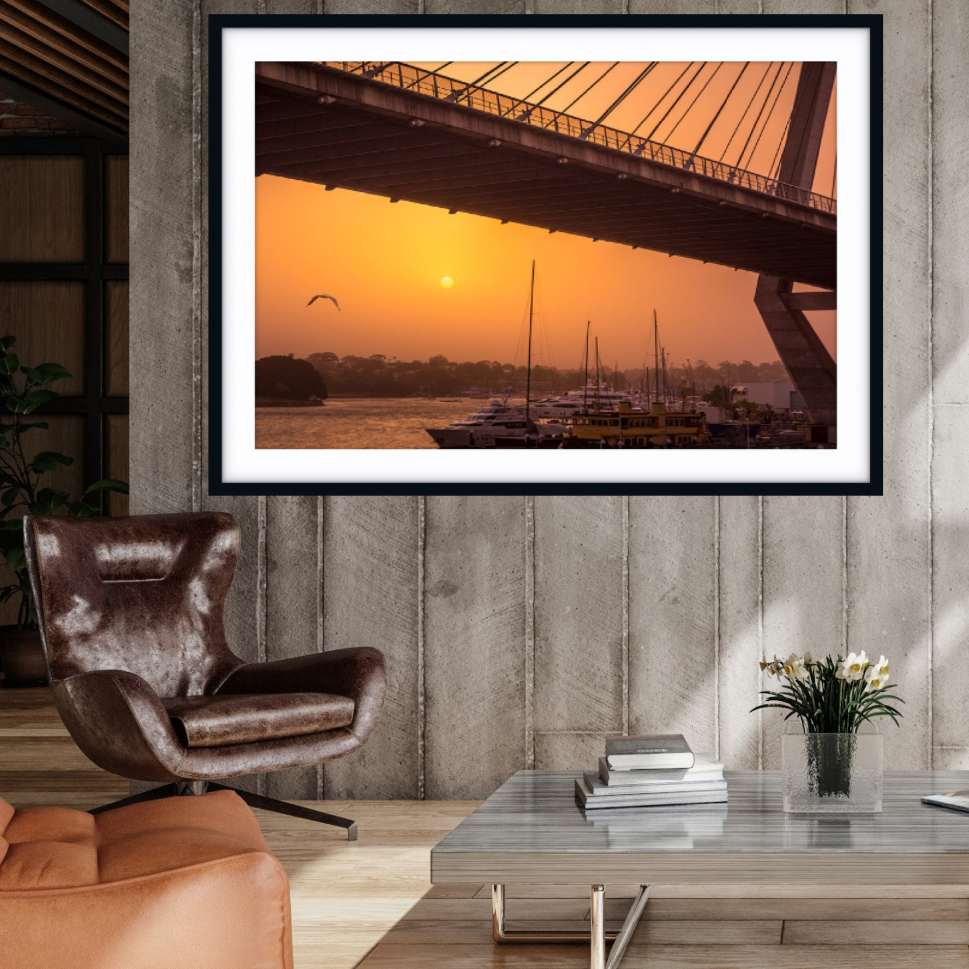 Framed fine art photograph of a sunset over Anzac Bridge in a living room setting.