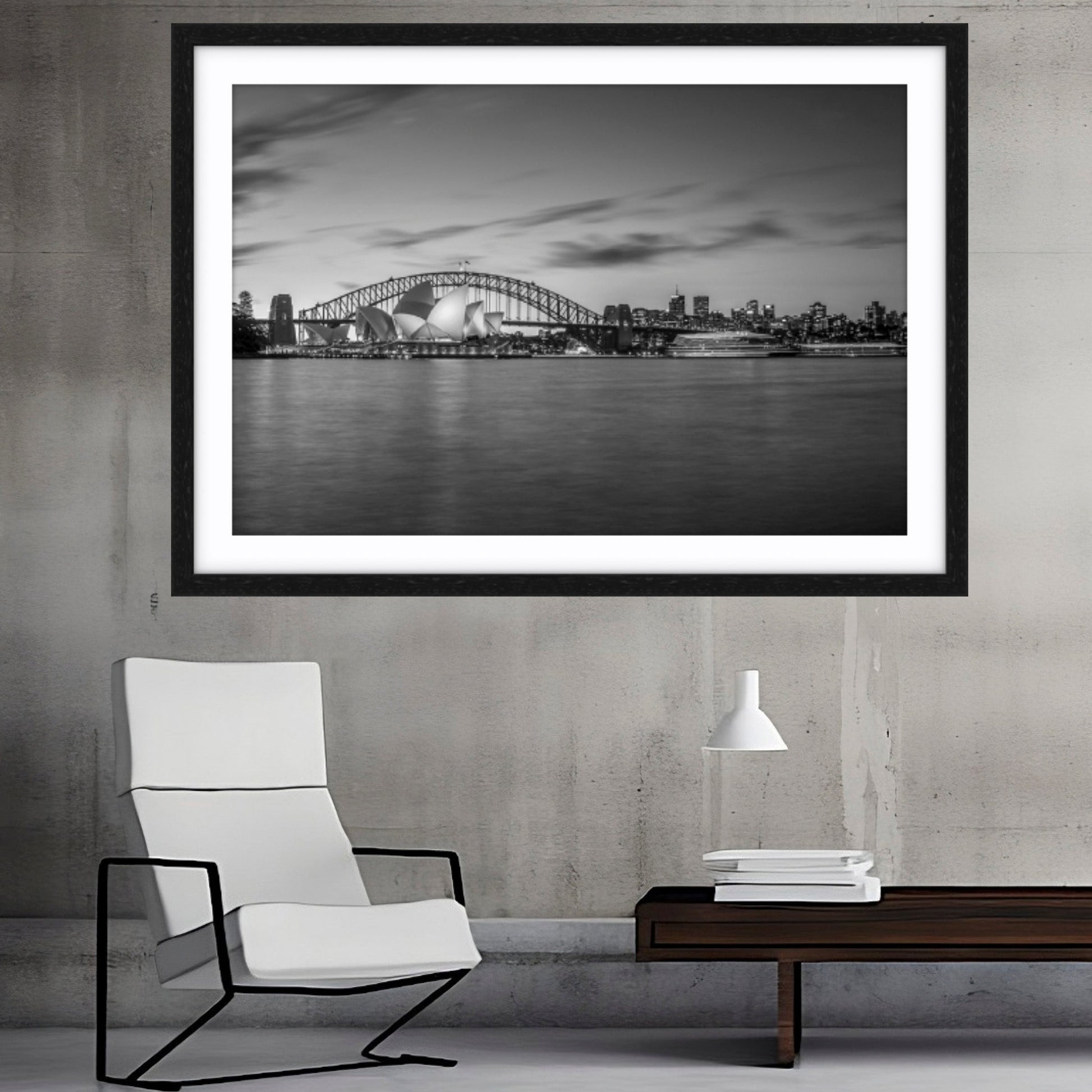 Framed fine art photograph black and white photograph of a Sydney Opera House and Sydney Harbour Bridge above a modern chair and table.