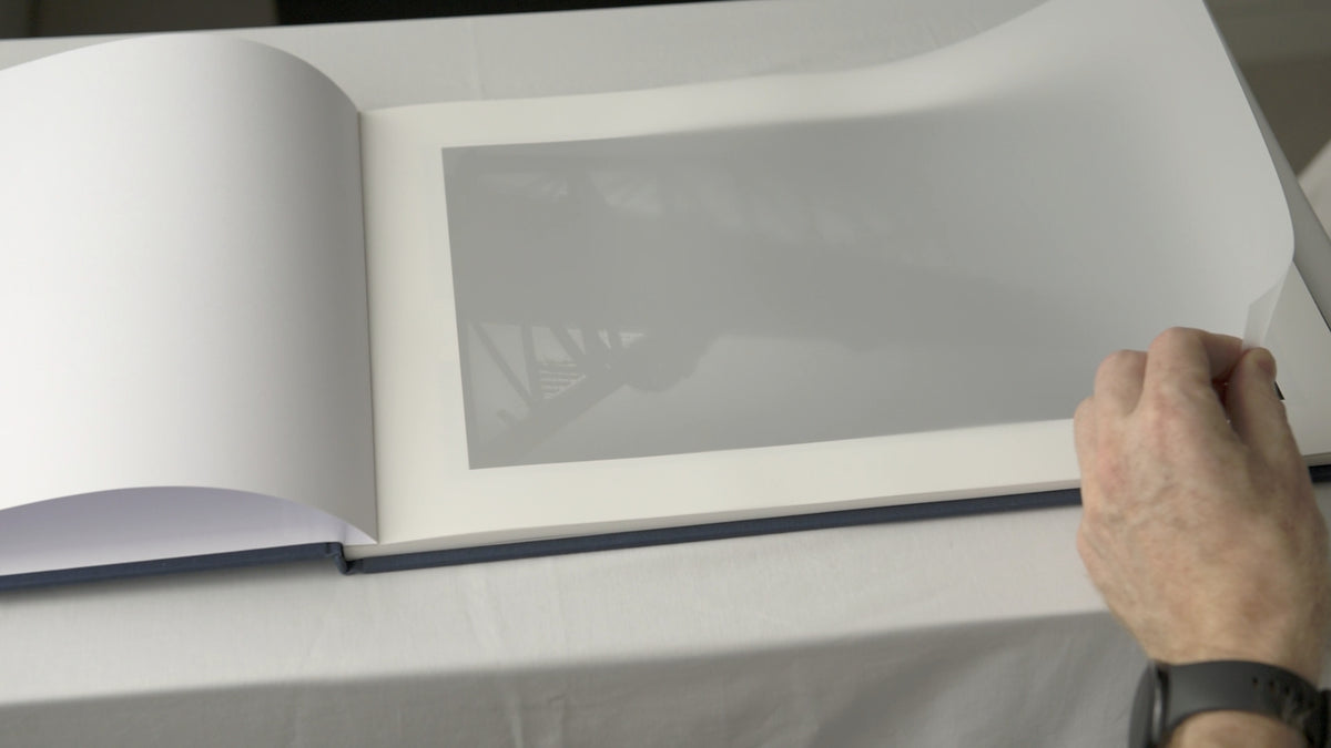 Load video: Pages of a fine art photography folio being turned
